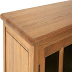 Close-up of a wooden sideboard with a focus on the top surface.