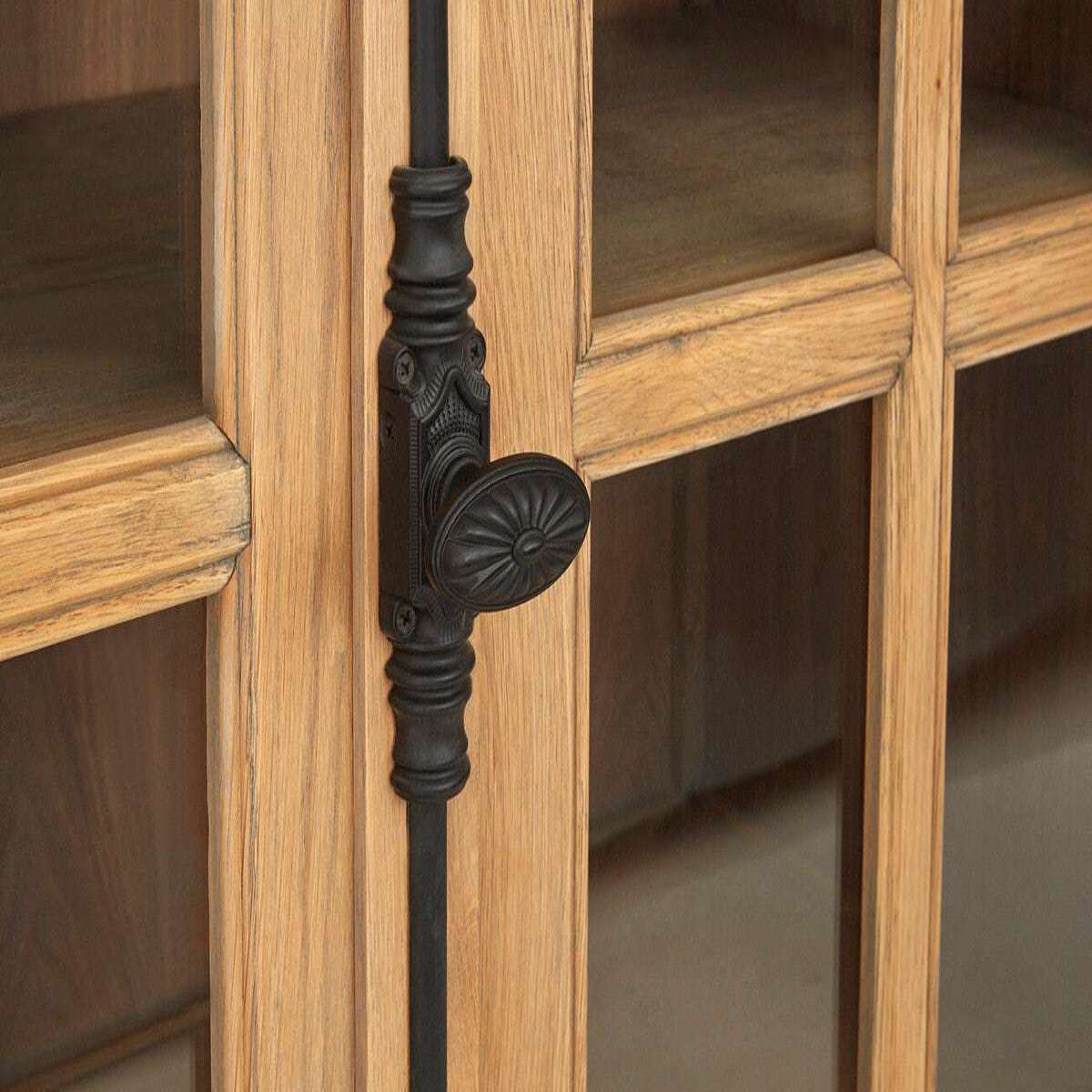 Close-up of a wooden cabinet with a decorative black handle