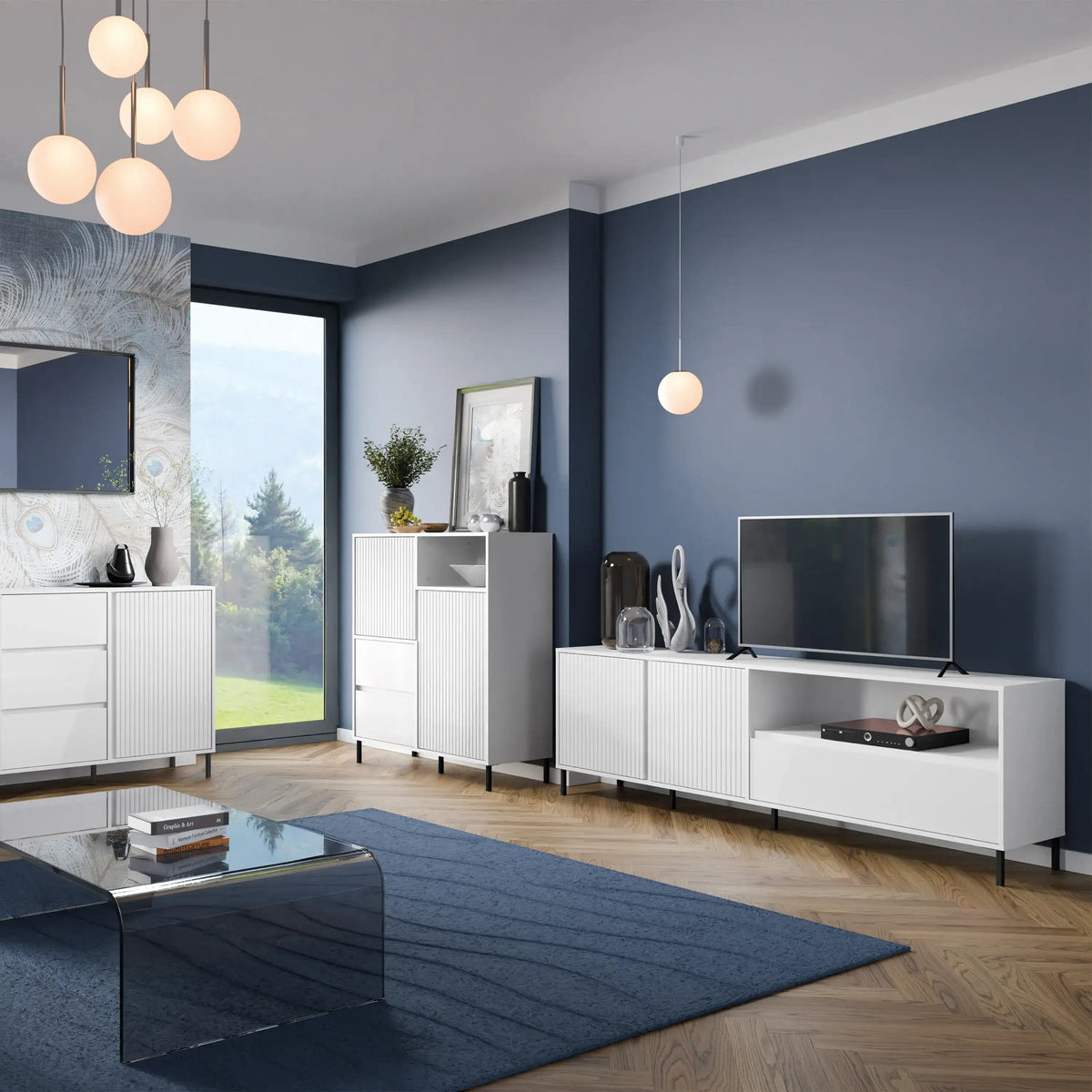 Modern living room with white furniture, TV, and decor against a blue wall.