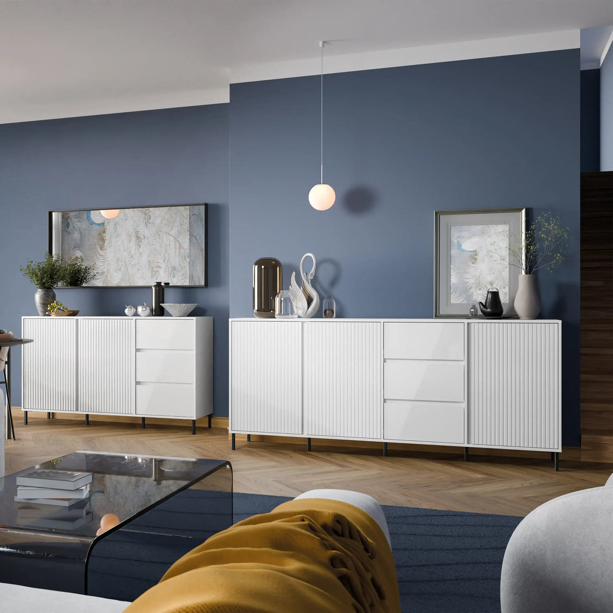 Modern living room with white furniture against a blue wall