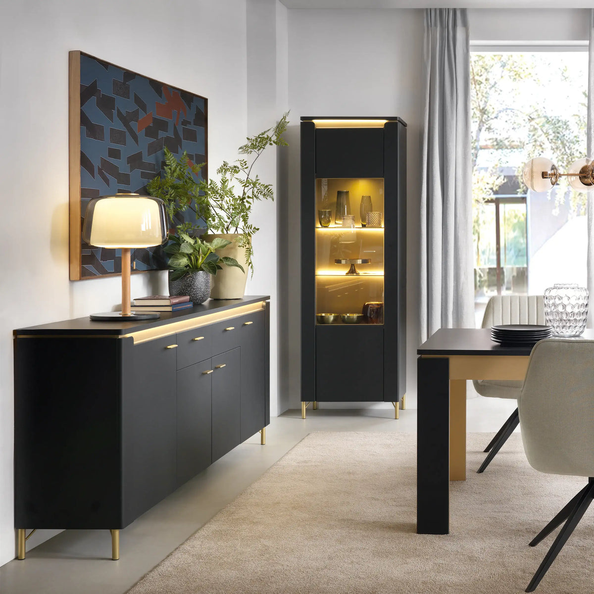 Modern interior with black sideboard, cabinet, and table in a well-lit room.