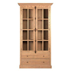 A tall wooden bookcase cabinet with two glass-paneled doors and two lower drawers, shown against a plain white background.