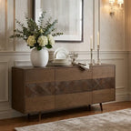 A mid-century modern wooden sideboard with six drawers, featuring a herringbone wood inlay pattern across the center. 