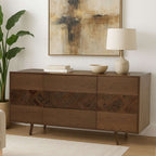 Wooden sideboard with decorative items in a room with abstract art and a lamp.
