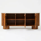 Wooden console table with decorative elements three interior shelves, and a light-colored stone top, shown against a plain white background.