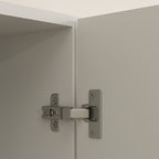 Cabinet hinge on a light gray door