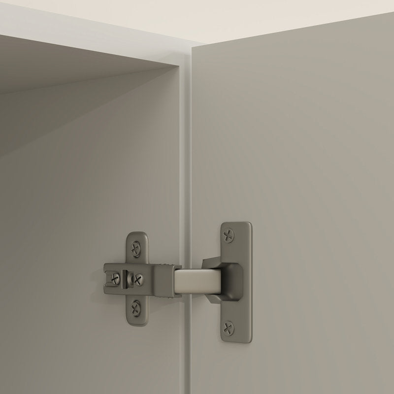Cabinet hinge on a light gray door