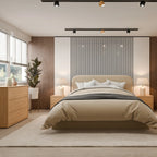 A modern bedroom featuring a beige upholstered bed centered against a black-and-white vertically striped accent wall. The room includes light wood nightstands, matching lamps, a wood dresser, a potted plant, and a large light rug on a pale wood floor.
