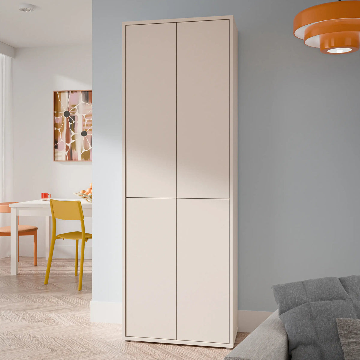 Beige wardrobe in a room with a gray wall, orange pendant light, and yellow chair.