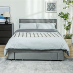 Gray upholstered bed with plaid blanket in a bedroom setting.