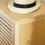 White straw hat with a black band on a wooden surface