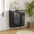 Black high-gloss cabinet with gold legs in a room with a plant and decor items.