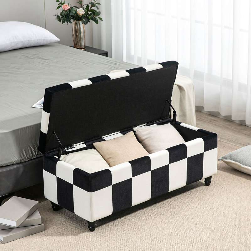 Black and white checkered ottoman with storage compartments in a bedroom setting.