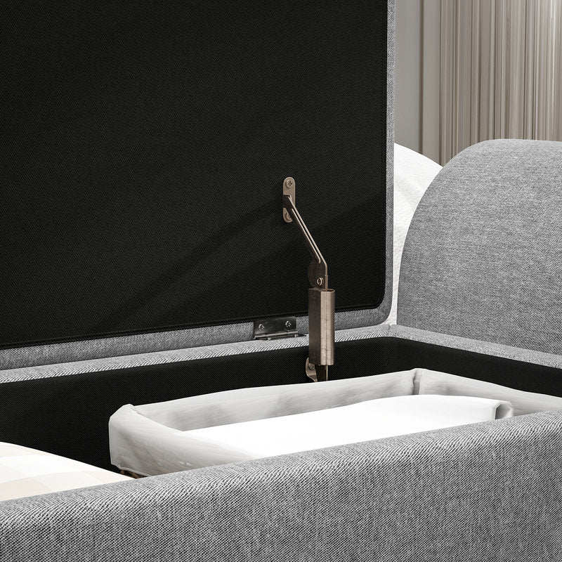Gray upholstered headboard with a black panel and brass bracket.