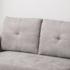 Gray sofa with tufted backrest on a white background