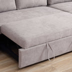 Gray sectional sofa with a pull-out bed mechanism on a wooden floor.