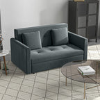 Gray sofa bed in a modern living room setting with a glass coffee table and metal cabinet.