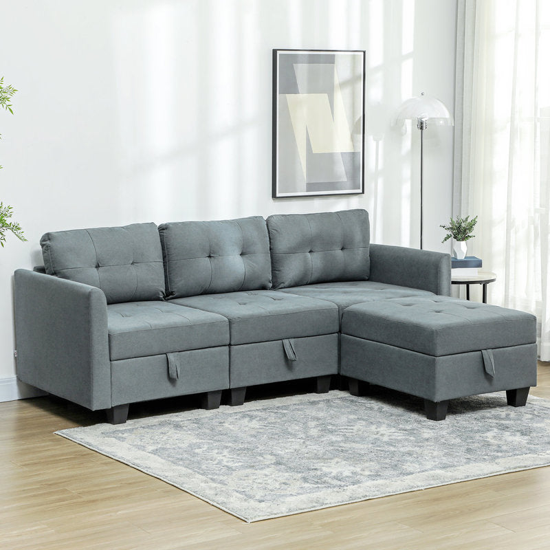 Gray sectional sofa in a living room setting with light wood flooring and white walls.