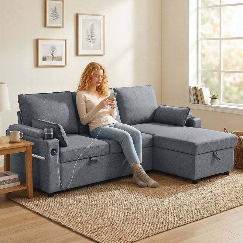 Woman sitting on a gray sectional sofa in a living room, using a smartphone.