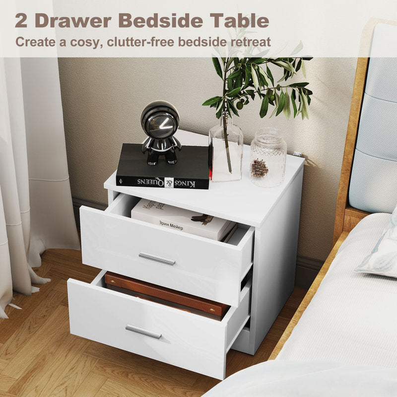 White two-drawer bedside table with decorative items in a bedroom setting.
