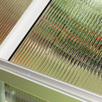 Close-up of a textured glass surface with a metallic frame.