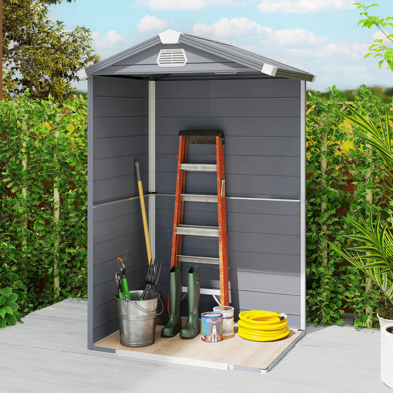 Gray garden shed with tools and equipment in a backyard setting