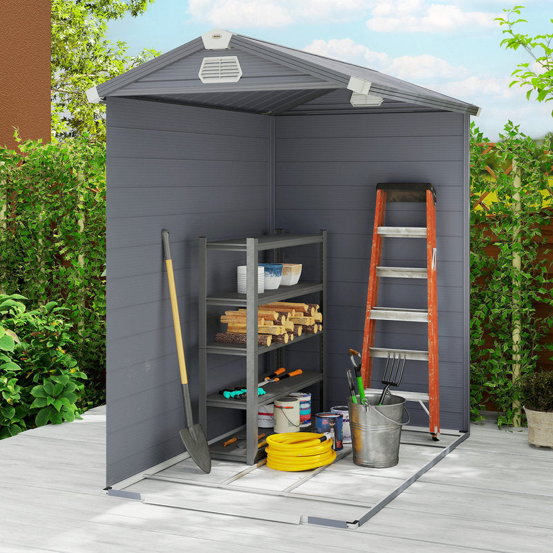 Gray outdoor storage shed with tools and supplies on a wooden deck