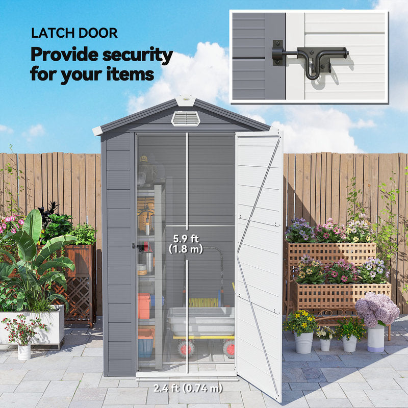 Garden shed with latch door feature, plants, and outdoor setting