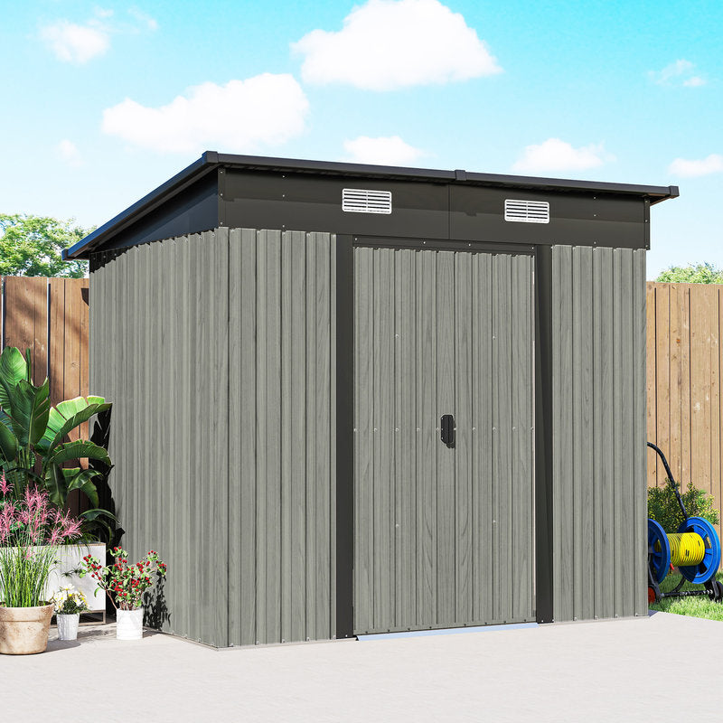 Gray metal storage shed with a black roof in a garden setting.