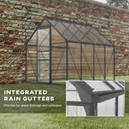 Greenhouse with integrated rain gutters highlighted on a grassy area and a brick wall in the background.