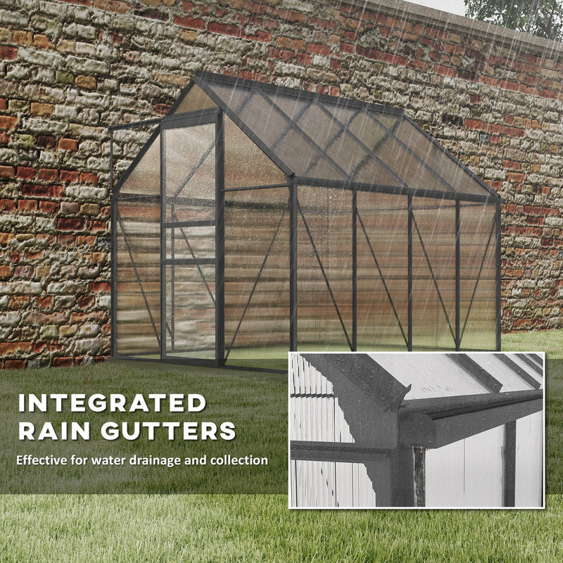 Greenhouse with integrated rain gutters highlighted on a grassy area and a brick wall in the background.