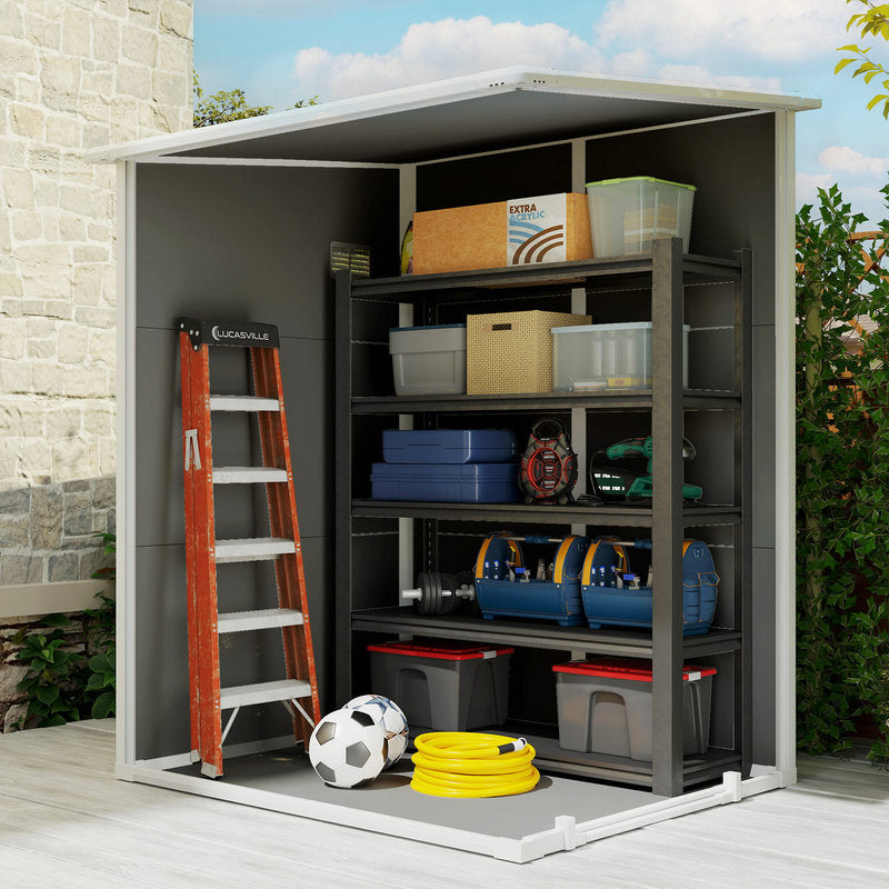 Gray storage shed with two open sides showing storage boxes on shelves and a ladder.