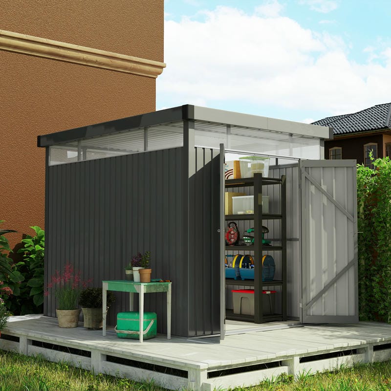 5.3 x 8.5ft dark grey galvanised steel garden shed with open door on a wooden platform surrounded by plants