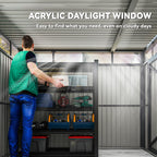 Person reaching into a storage unit with an acrylic daylight window, showing tools and equipment inside.