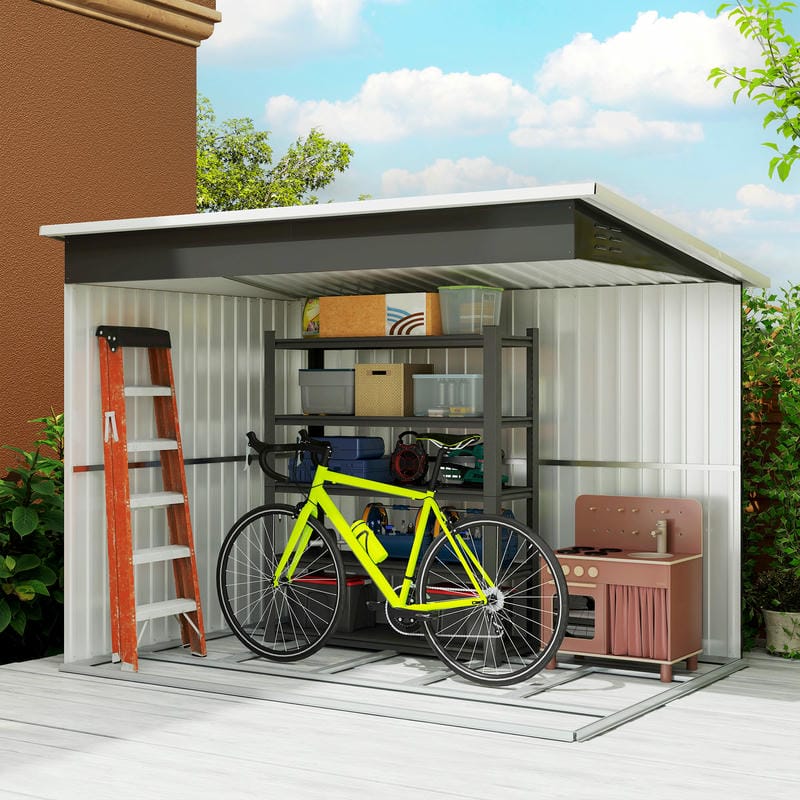 Outdoor storage shed with a bicycle, ladder, and various items on a sunny day.