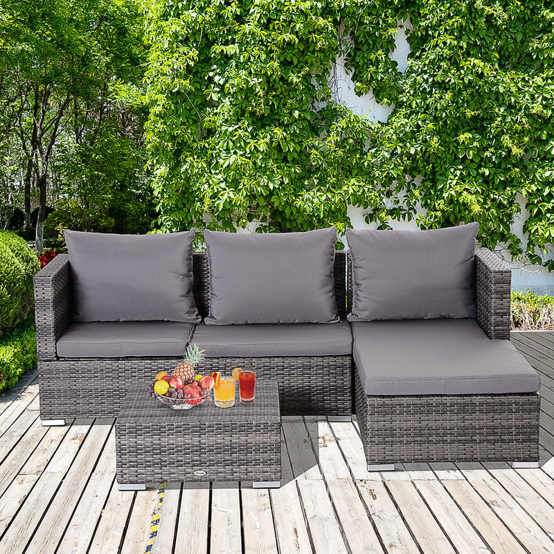 Outdoor patio furniture set with gray cushions on a wooden deck.