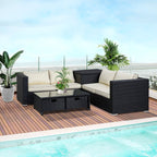 Outdoor patio furniture set with cushions by a pool on a wooden deck.