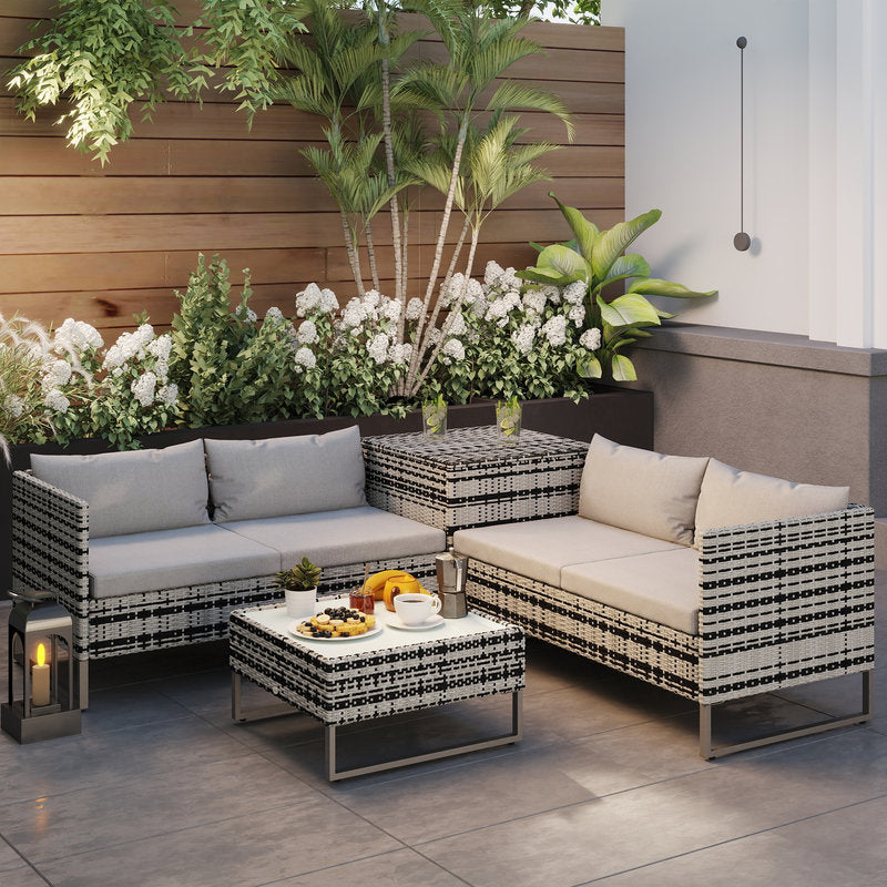 Outdoor patio furniture set with cushions on a patio area with plants and flowers.