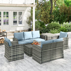 Outdoor patio furniture set with wicker chairs and table on a wooden deck.