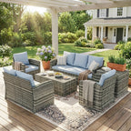 Outdoor patio set with cushions on a wooden deck in a garden setting.