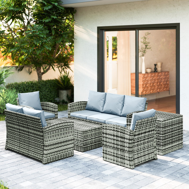 Outdoor patio furniture set with cushions on a patio area.