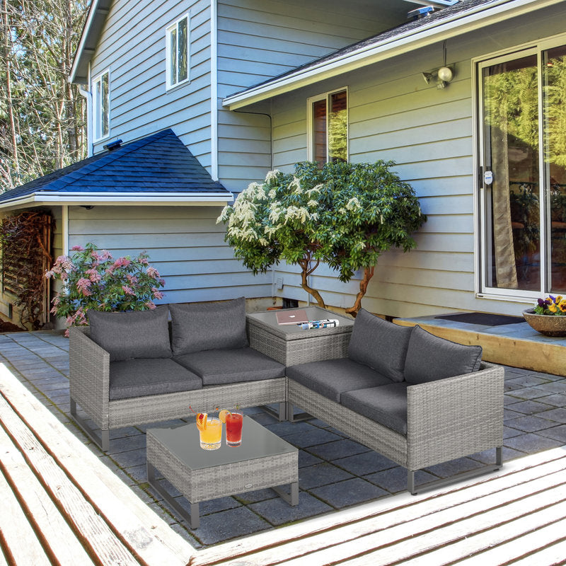 Outdoor patio with gray sectional sofa, coffee table, and decorative items on a patio deck.