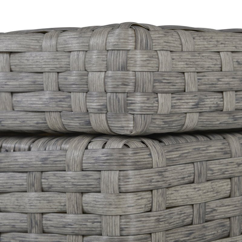 Two woven baskets stacked on top of each other with a white background