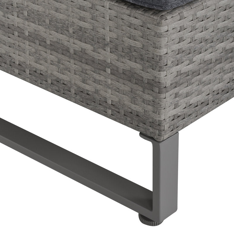 Close-up of a gray wicker outdoor chair corner with metal legs on a white background