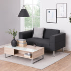 Modern living room with a gray sofa, wooden coffee table, and decorative elements.