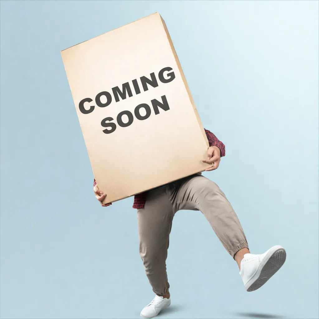A person in beige pants and white sneakers holds a large cardboard box with the words 'COMING SOON' printed on the front.