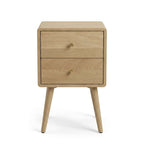 A light natural oak two-drawer nightstand with tapered legs and small round wooden knobs, shown against a plain white background.